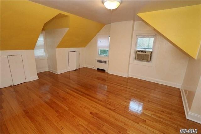 85-24 Eton St, Jamaica Estates, NY 11432 - bonus room with radiator heating unit, cooling unit, wood finished floors, and lofted ceiling
