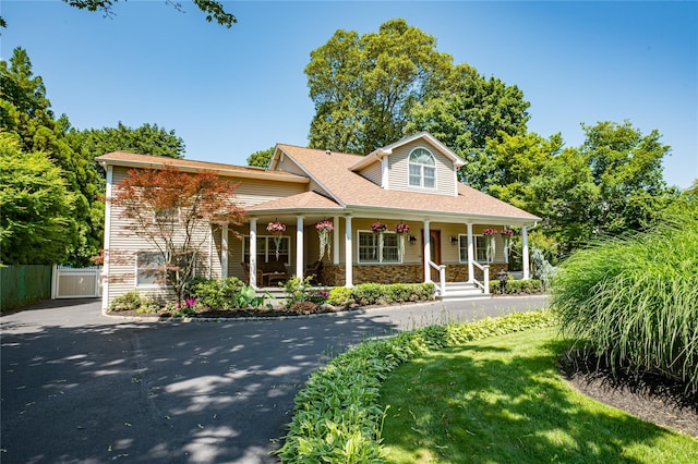 122 Cambon Ave, Saint James, NY 11780 - view of front of property featuring a porch, asphalt driveway, stone siding, and a shingled roof