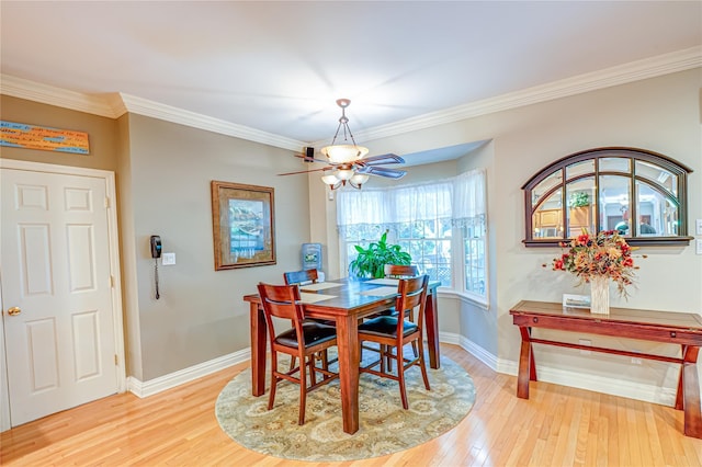 122 Cambon Ave, Saint James, NY 11780 - dining area featuring light wood finished floors and ornamental molding