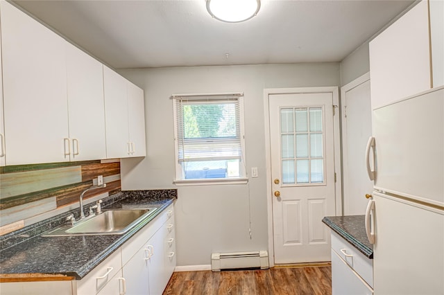 122 Cambon Ave, Saint James, NY 11780 - kitchen with freestanding refrigerator, a baseboard heating unit, dark wood-style flooring, white cabinets, and dark stone countertops