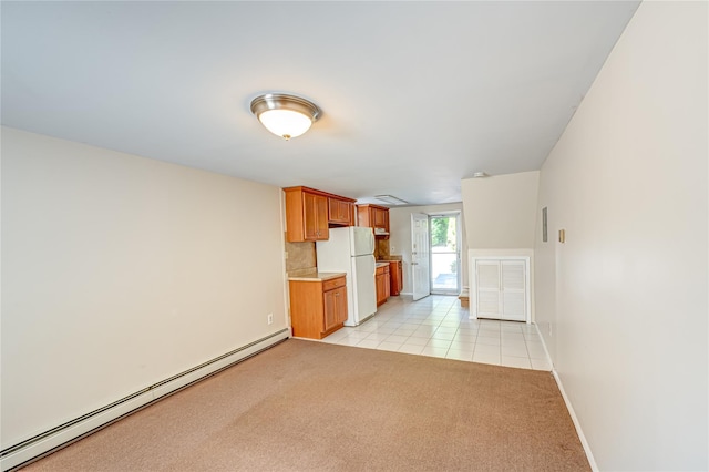 122 Cambon Ave, Saint James, NY 11780 - kitchen featuring a baseboard radiator, freestanding refrigerator, light countertops, light colored carpet, and light tile patterned floors