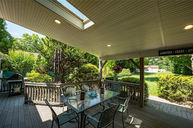 122 Cambon Ave, Saint James, NY 11780 - wooden terrace with outdoor dining space, a grill, and a lawn