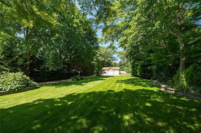 122 Cambon Ave, Saint James, NY 11780 - view of grassy yard featuring a garage