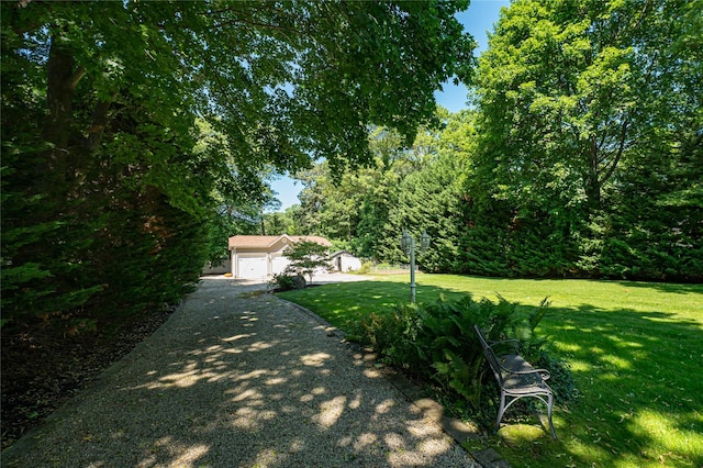 122 Cambon Ave, Saint James, NY 11780 - view of green lawn with a garage, driveway, and an outdoor structure