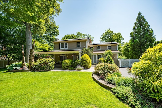 122 Cambon Ave, Saint James, NY 11780 - rear view of property featuring a gate, roof mounted solar panels, a porch, and a chimney