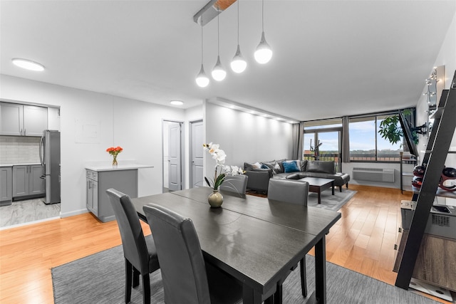 150-38 Union Tpke Unit 7R, Flushing, NY 11367 - dining space with light wood-style flooring and a wall unit AC