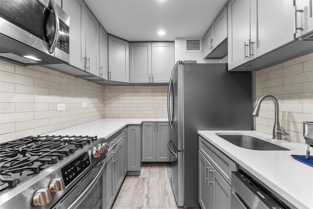 150-38 Union Tpke Unit 7R, Flushing, NY 11367 - kitchen featuring stainless steel appliances, gray cabinetry, decorative backsplash, light countertops, and light marble finish floors