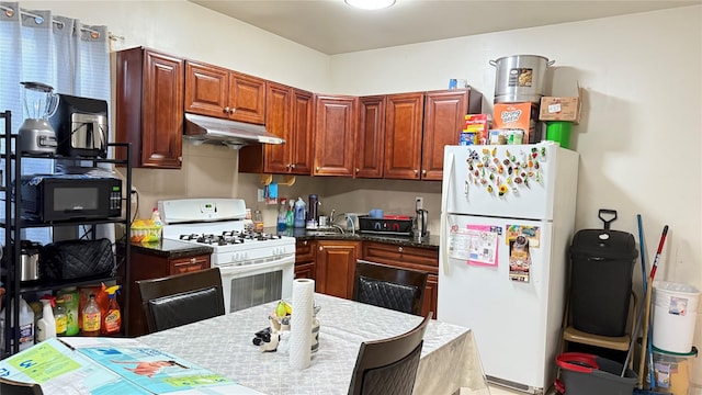 9721 Alstyne Ave, Corona, NY 11368 - kitchen with white appliances and under cabinet range hood