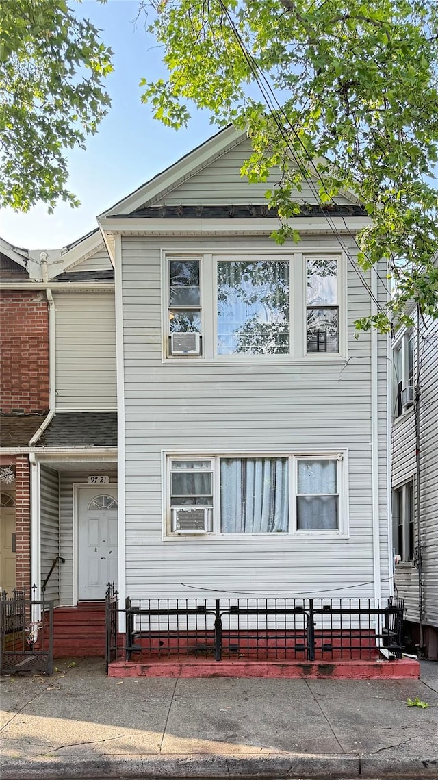 9721 Alstyne Ave, Corona, NY 11368 - view of front facade with a fenced front yard and cooling unit