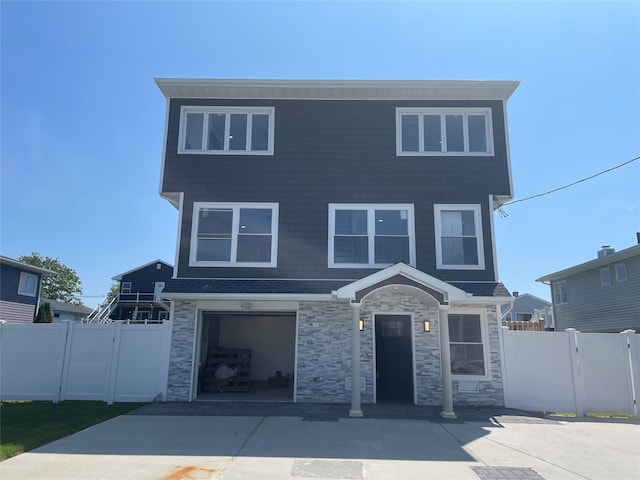 503 Nassau Ave, Freeport, NY 11520 - view of front of house featuring driveway, a garage, and stone siding