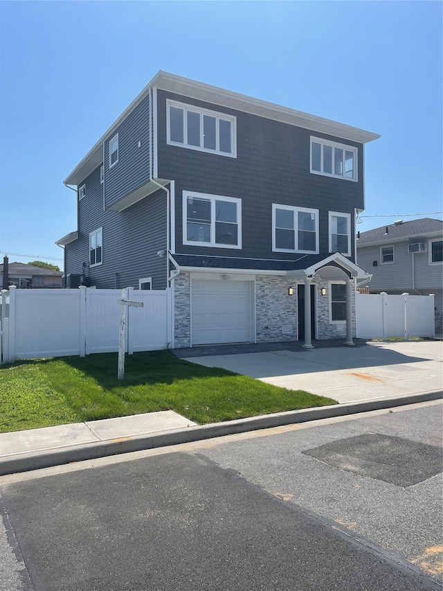 503 Nassau Ave, Freeport, NY 11520 - townhome / multi-family property with stone siding, an attached garage, and concrete driveway