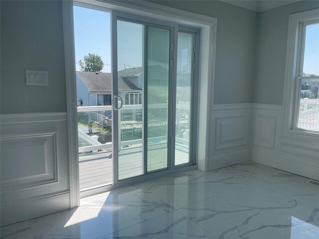 503 Nassau Ave, Freeport, NY 11520 - unfurnished room featuring marble finish floors, wainscoting, and a decorative wall