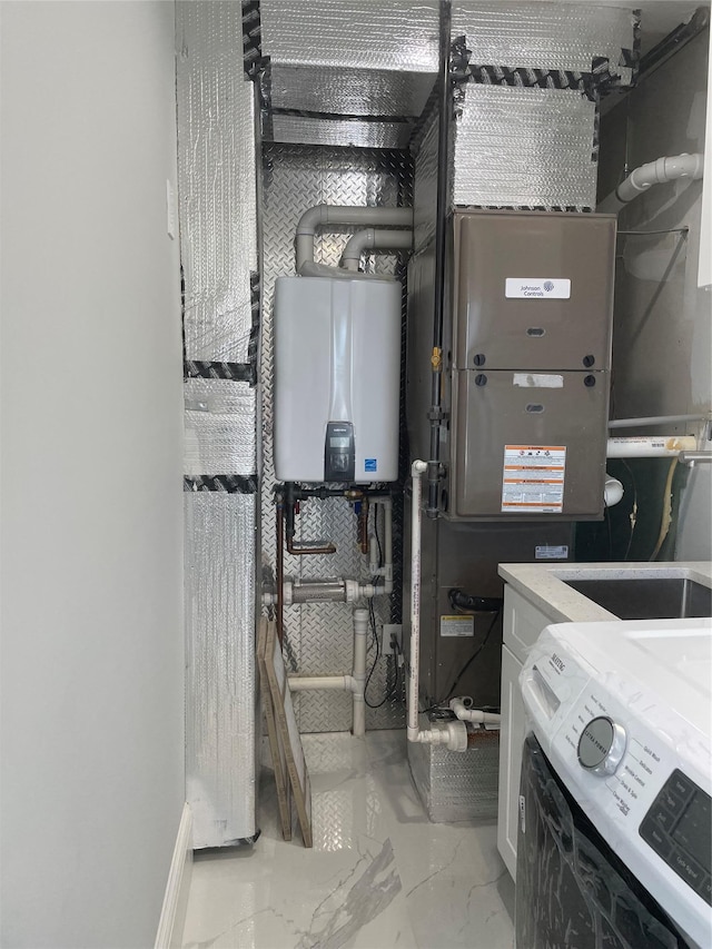 503 Nassau Ave, Freeport, NY 11520 - utility room featuring washer / dryer and tankless water heater