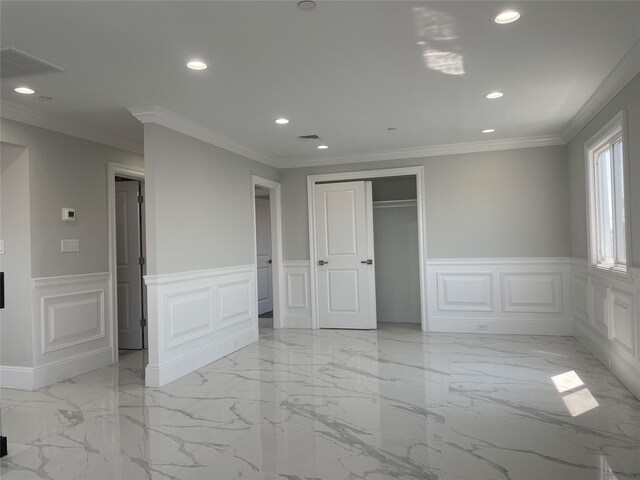 503 Nassau Ave, Freeport, NY 11520 - unfurnished bedroom with a decorative wall, recessed lighting, light marble finish flooring, wainscoting, and ornamental molding