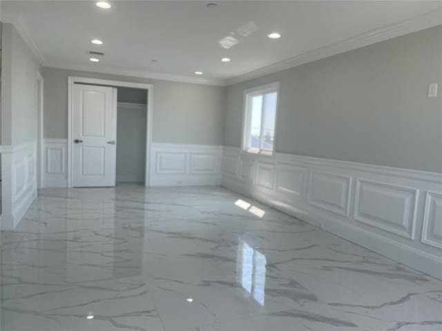 503 Nassau Ave, Freeport, NY 11520 - spare room featuring a decorative wall, recessed lighting, light marble finish flooring, ornamental molding, and wainscoting
