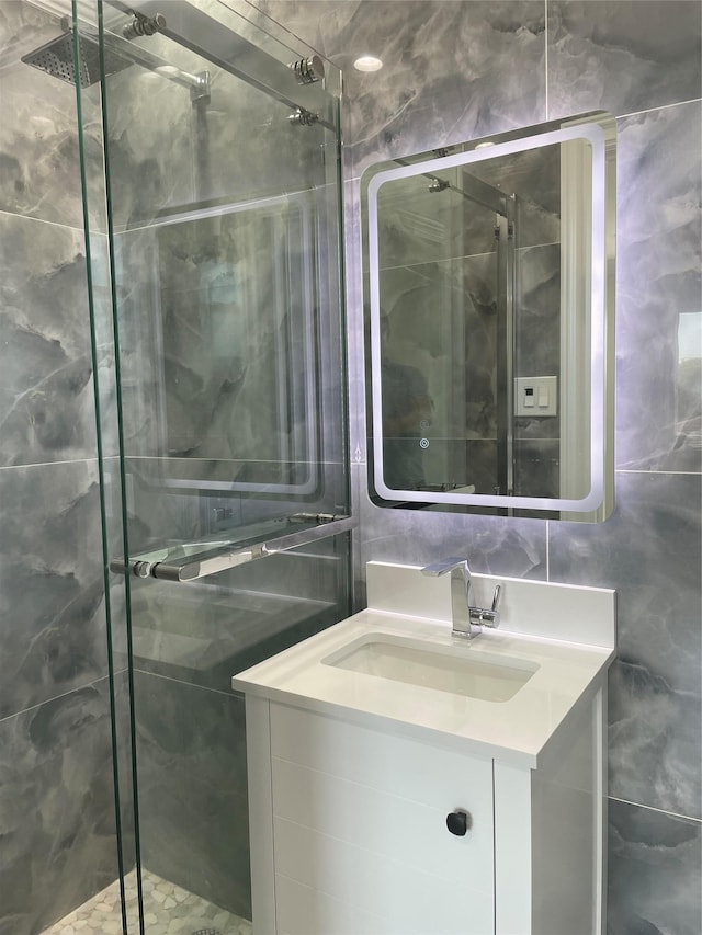 503 Nassau Ave, Freeport, NY 11520 - bathroom featuring a stall shower, vanity, and tile walls