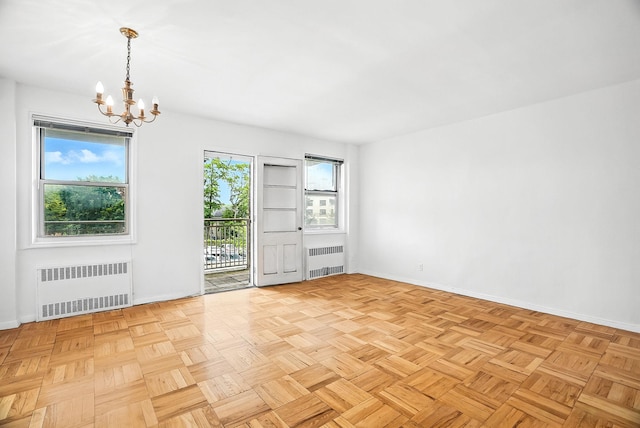 1255 N Ave Unit 2F, New Rochelle, NY 10804 - empty room featuring radiator and a chandelier