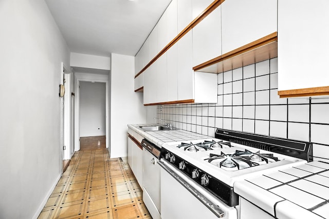 1255 N Ave Unit 2F, New Rochelle, NY 10804 - kitchen with white appliances, white cabinetry, tasteful backsplash, and tile counters