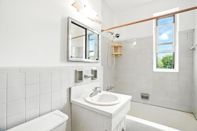 1255 N Ave Unit 2F, New Rochelle, NY 10804 - bathroom featuring bathing tub / shower combination, tile walls, vanity, and wainscoting
