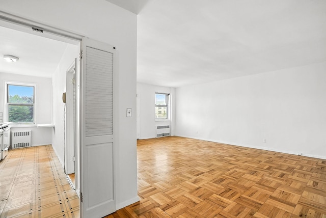 1255 N Ave Unit 2F, New Rochelle, NY 10804 - hallway featuring radiator heating unit and healthy amount of natural light
