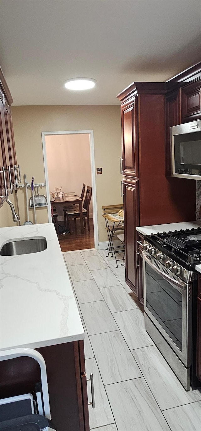 3344 Junction Blvd Unit 2X, Jackson Heights, NY 11372 - kitchen featuring appliances with stainless steel finishes, light marble finish floors, and light stone countertops
