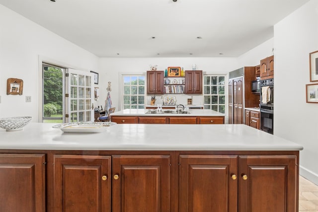 783 N Clove Rd, Millbrook, NY 12545 - kitchen with light countertops, stainless steel microwave, an island with sink, and plenty of natural light