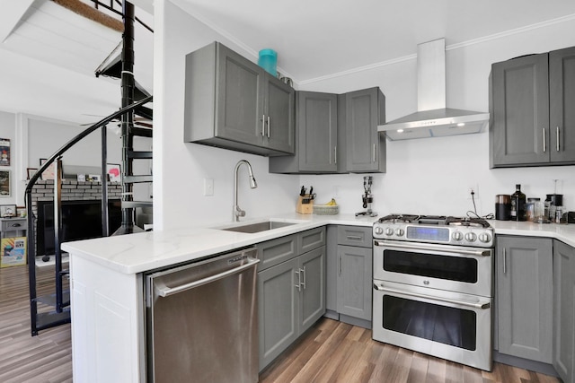 525 Myrtle Ave, Gardiner, NY 12589 - kitchen with wall chimney range hood, appliances with stainless steel finishes, gray cabinets, light wood-style floors, and light stone countertops