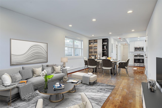 89-25 127th St, Richmond Hill, NY 11418 - living area featuring a baseboard radiator, light wood-type flooring, and recessed lighting