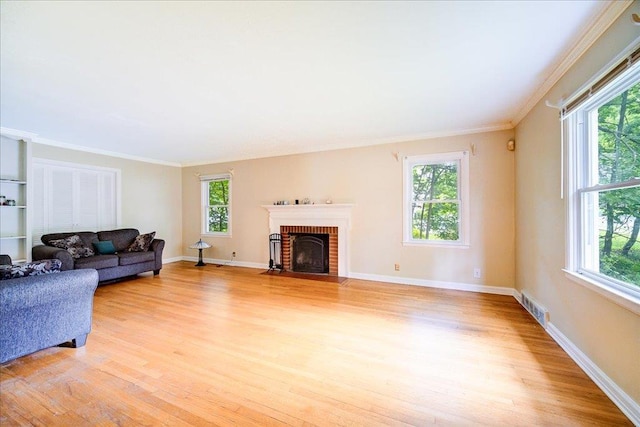 17 Seaman Rd, Poughkeepsie, NY 12601 - living area featuring light wood-type flooring, crown molding, and a brick fireplace