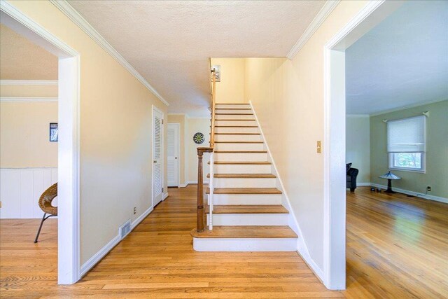 17 Seaman Rd, Poughkeepsie, NY 12601 - staircase with wood finished floors, crown molding, and a textured ceiling