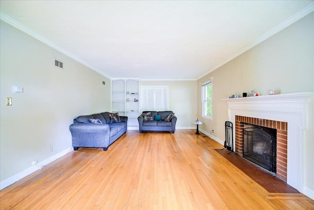 17 Seaman Rd, Poughkeepsie, NY 12601 - living room featuring wood finished floors, a brick fireplace, crown molding, and built in shelves