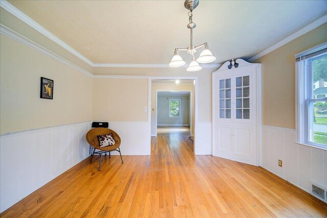 17 Seaman Rd, Poughkeepsie, NY 12601 - unfurnished dining area featuring a chandelier, light wood finished floors, wainscoting, and ornamental molding