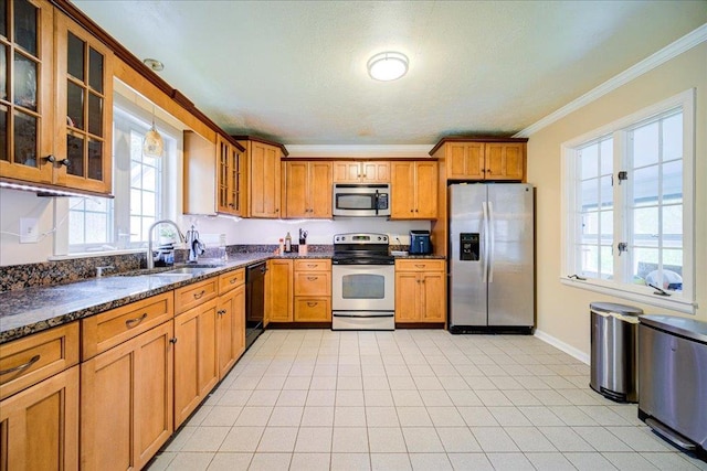 17 Seaman Rd, Poughkeepsie, NY 12601 - kitchen with stainless steel appliances, crown molding, brown cabinetry, glass insert cabinets, and dark stone countertops