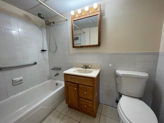 100 Clinton Ave Unit 3P, Mineola, NY 11501 - bathroom featuring tile patterned flooring, shower / washtub combination, vanity, tile walls, and wainscoting