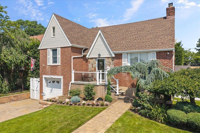 17 Acorn Rd, East Rockaway, NY 11518 - tudor-style house featuring a chimney, brick siding, a front yard, and roof with shingles