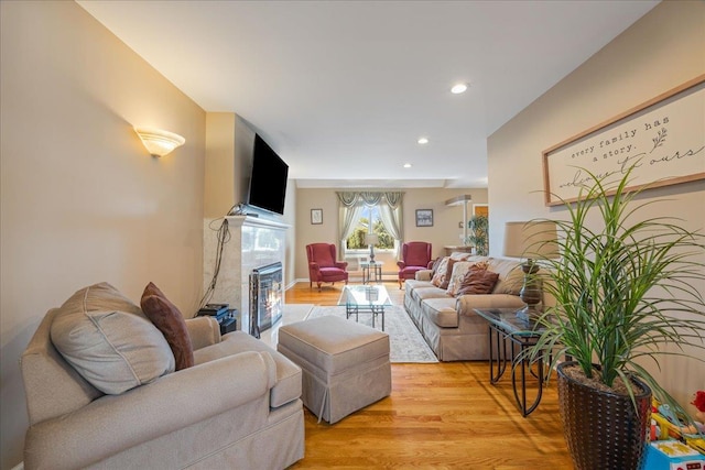17 Acorn Rd, East Rockaway, NY 11518 - living area featuring light wood finished floors, a glass covered fireplace, and recessed lighting