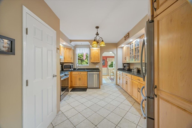 17 Acorn Rd, East Rockaway, NY 11518 - kitchen with stainless steel appliances, dark countertops, light tile patterned floors, and arched walkways