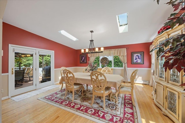 17 Acorn Rd, East Rockaway, NY 11518 - dining area featuring a skylight, vaulted ceiling, light wood finished floors, a chandelier, and healthy amount of natural light