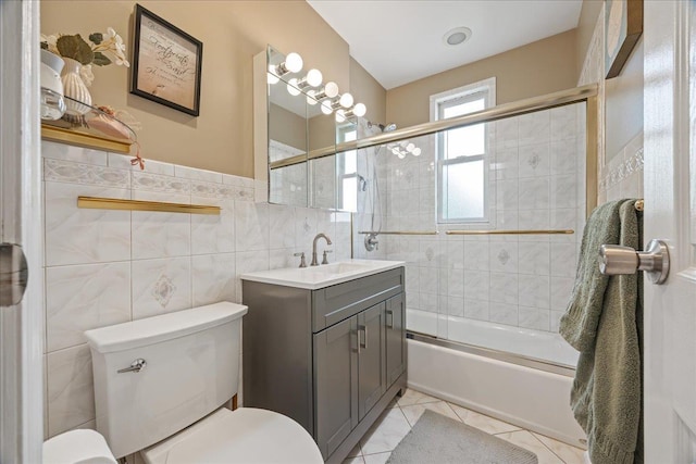 17 Acorn Rd, East Rockaway, NY 11518 - bathroom with vanity, shower / bath combination with glass door, tile walls, and tile patterned floors