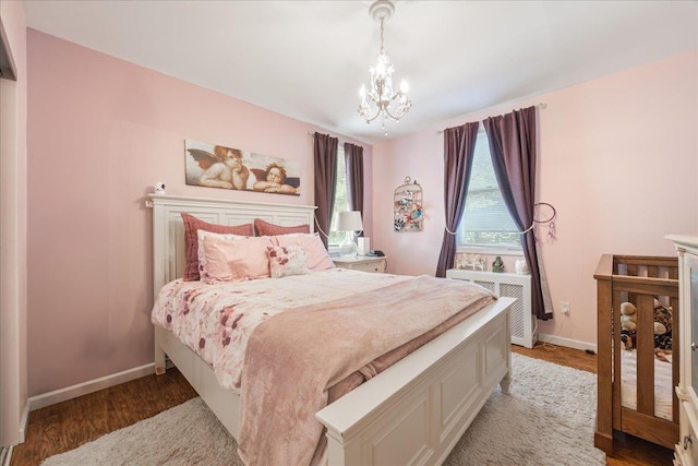 17 Acorn Rd, East Rockaway, NY 11518 - bedroom with a chandelier, radiator, and light wood-type flooring