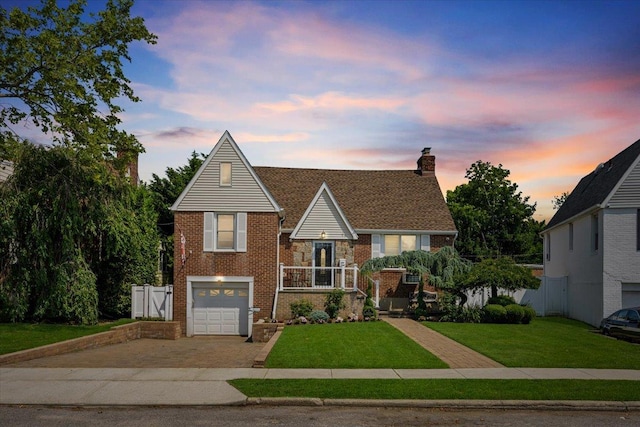 17 Acorn Rd, East Rockaway, NY 11518 - view of front facade with decorative driveway, brick siding, an attached garage, and a chimney