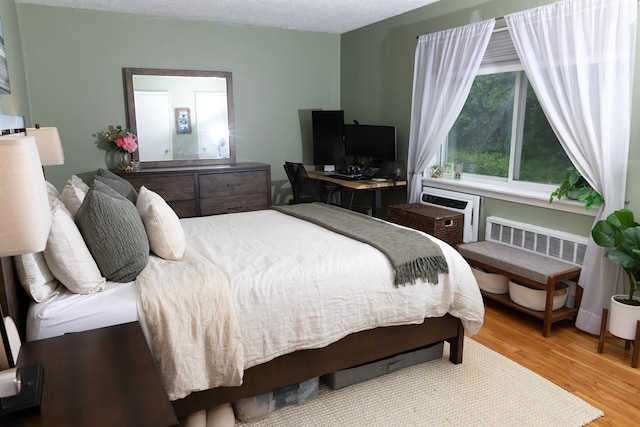 304 Fenimore Rd Unit 7A, Mamaroneck, NY 10543 - bedroom featuring wood finished floors and a wall unit AC