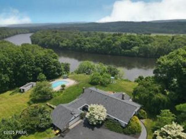 312 E Ann St, Milford, PA 18337 - aerial view of property and surrounding area with a nearby body of water and a heavily wooded area
