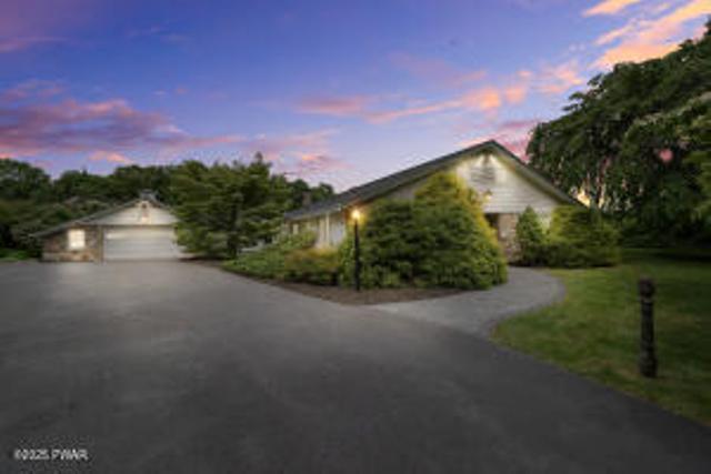 312 E Ann St, Milford, PA 18337 - view of front of property with a garage and asphalt driveway