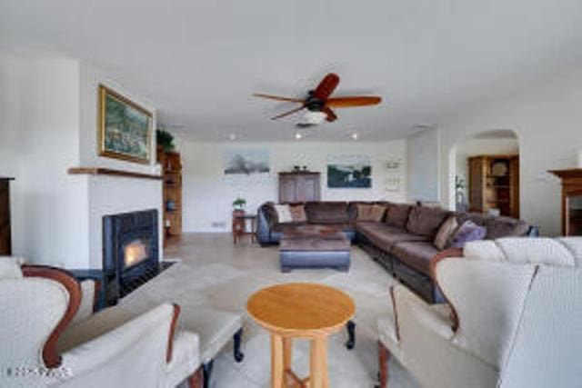 312 E Ann St, Milford, PA 18337 - living room with a lit fireplace, a ceiling fan, and arched walkways