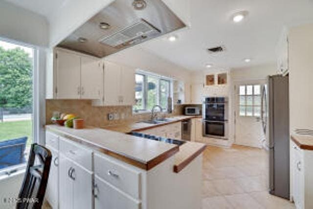 312 E Ann St, Milford, PA 18337 - kitchen with appliances with stainless steel finishes, plenty of natural light, a peninsula, tasteful backsplash, and recessed lighting