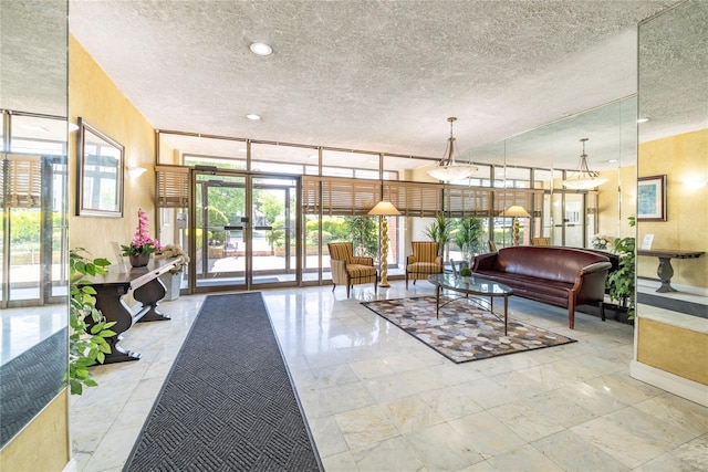 85 S Centre Ave Unit A17, Rockville Centre, NY 11570 - lobby with a textured ceiling and floor to ceiling windows