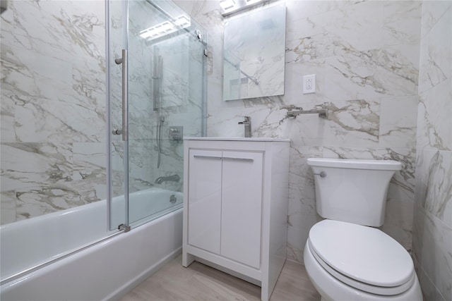 85 S Centre Ave Unit A17, Rockville Centre, NY 11570 - full bathroom with combined bath / shower with glass door, vanity, and tile walls
