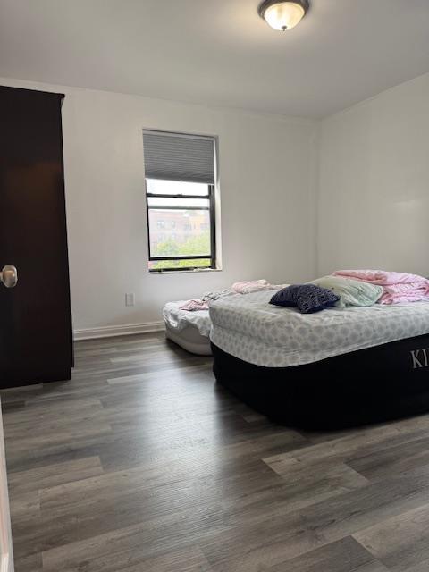 44-16 Macnish St Unit 5B, Elmhurst, NY 11373 - bedroom featuring baseboards and wood finished floors