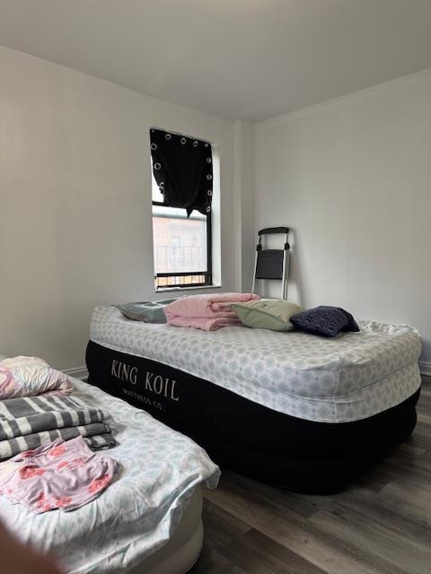 44-16 Macnish St Unit 5B, Elmhurst, NY 11373 - bedroom with dark wood finished floors